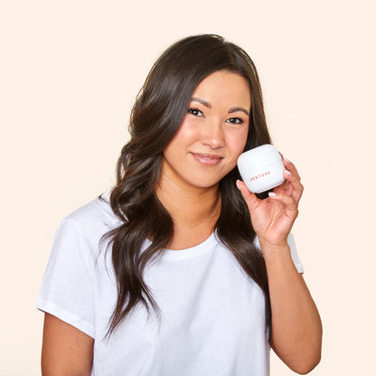 Image of a woman holding the ScalpStim Derma Roller.