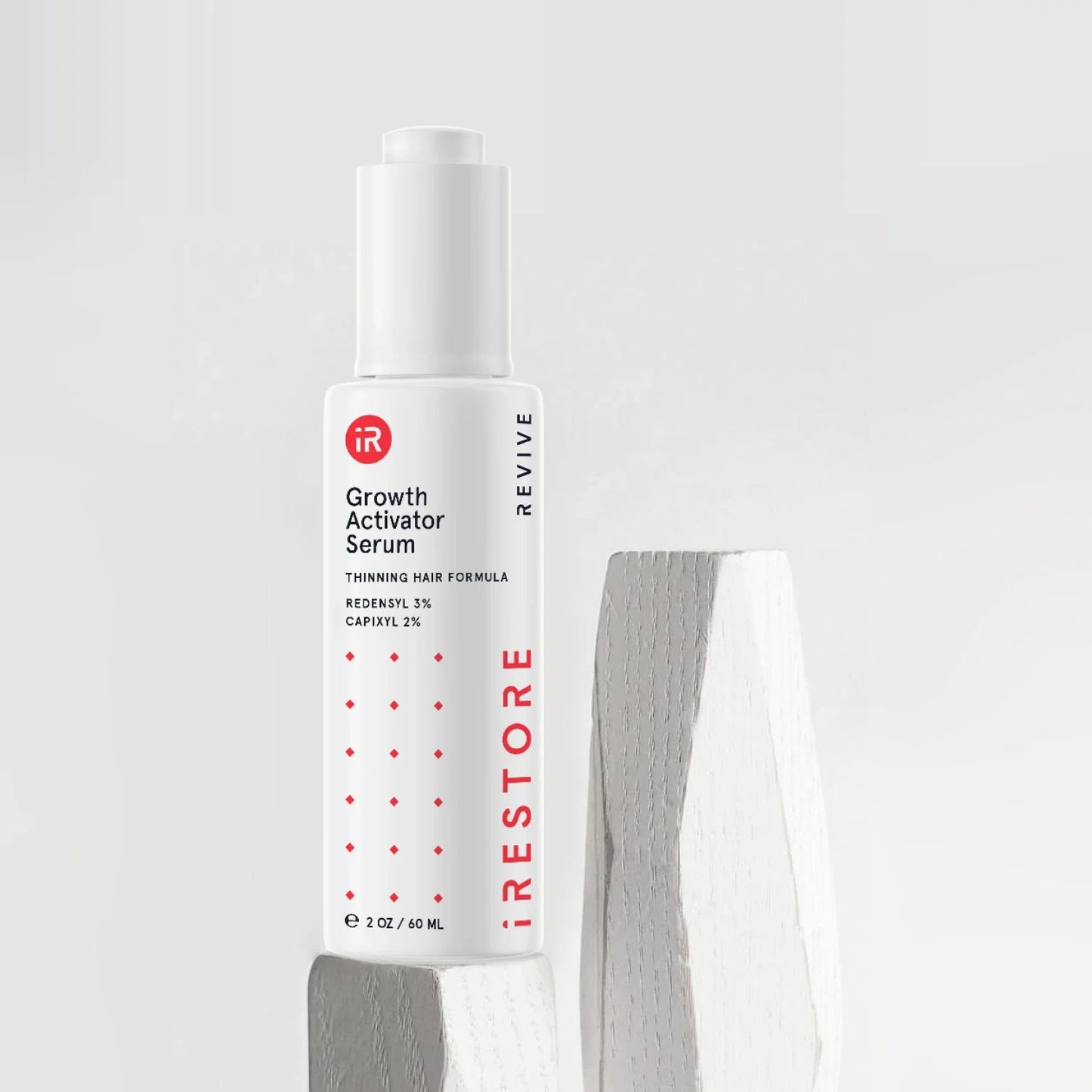 Growth activator serum on top of white wood