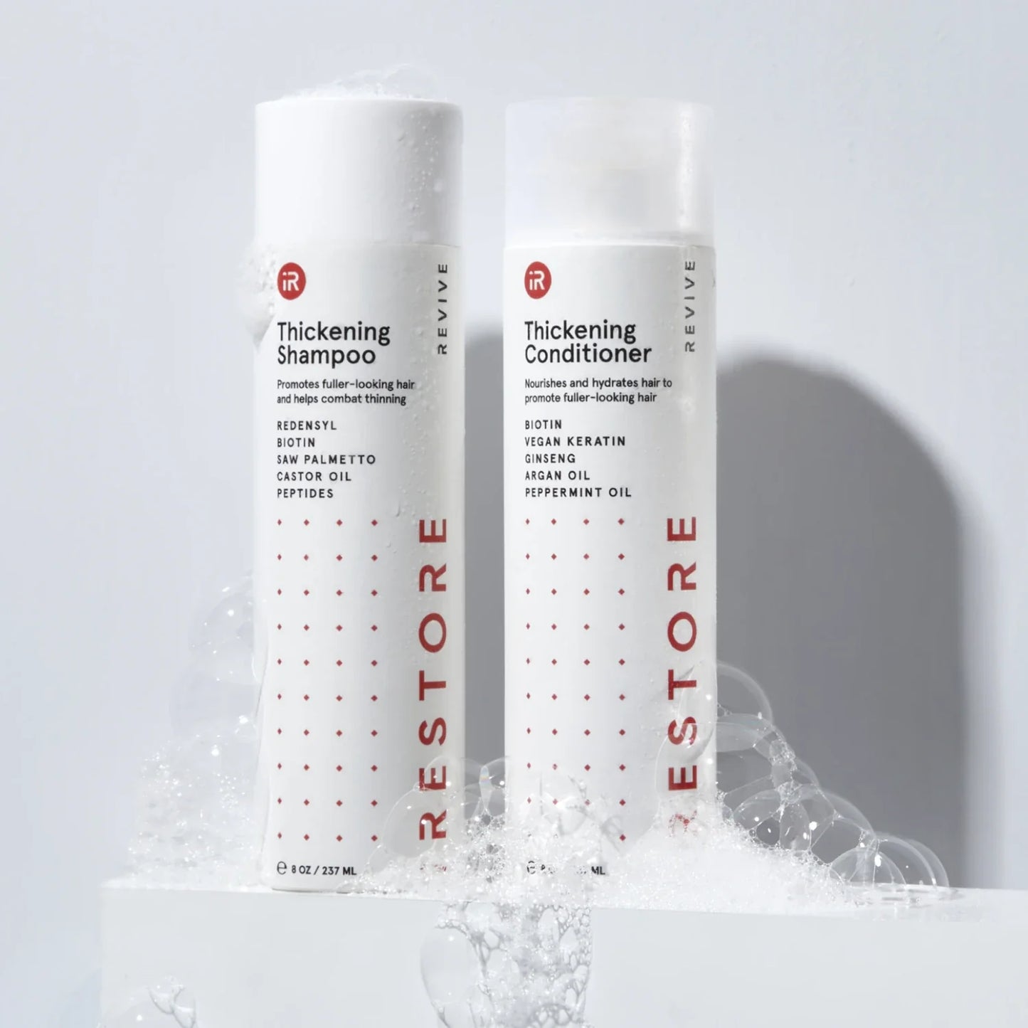 Image showing the Thickening Shampoo and Conditioner with bubbles around the bottle.