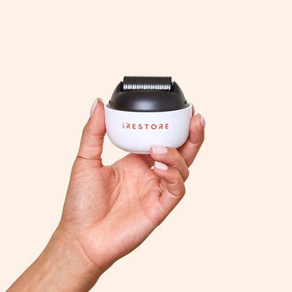 Close up shot image of a hand holding the ScalpStim Derma Roller.