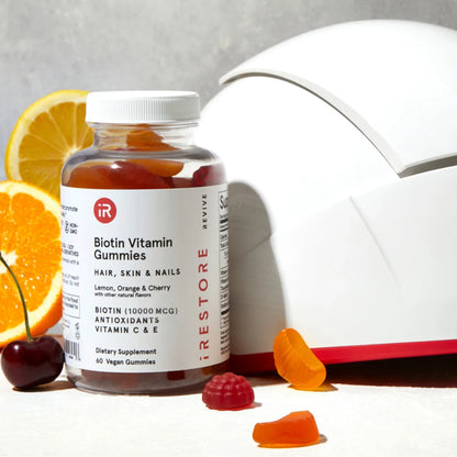 Biotin vitamin gummies with irestore professional device behind it.