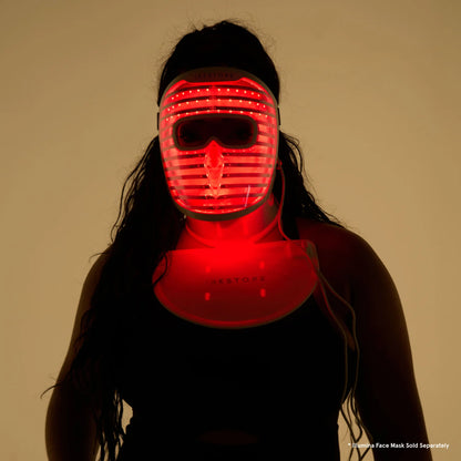 Silhouette of a woman wearing both the LED face mask and LED neck and chest mask with red light turned on. Disclaimer below saying "Illumina face mask sold separately"