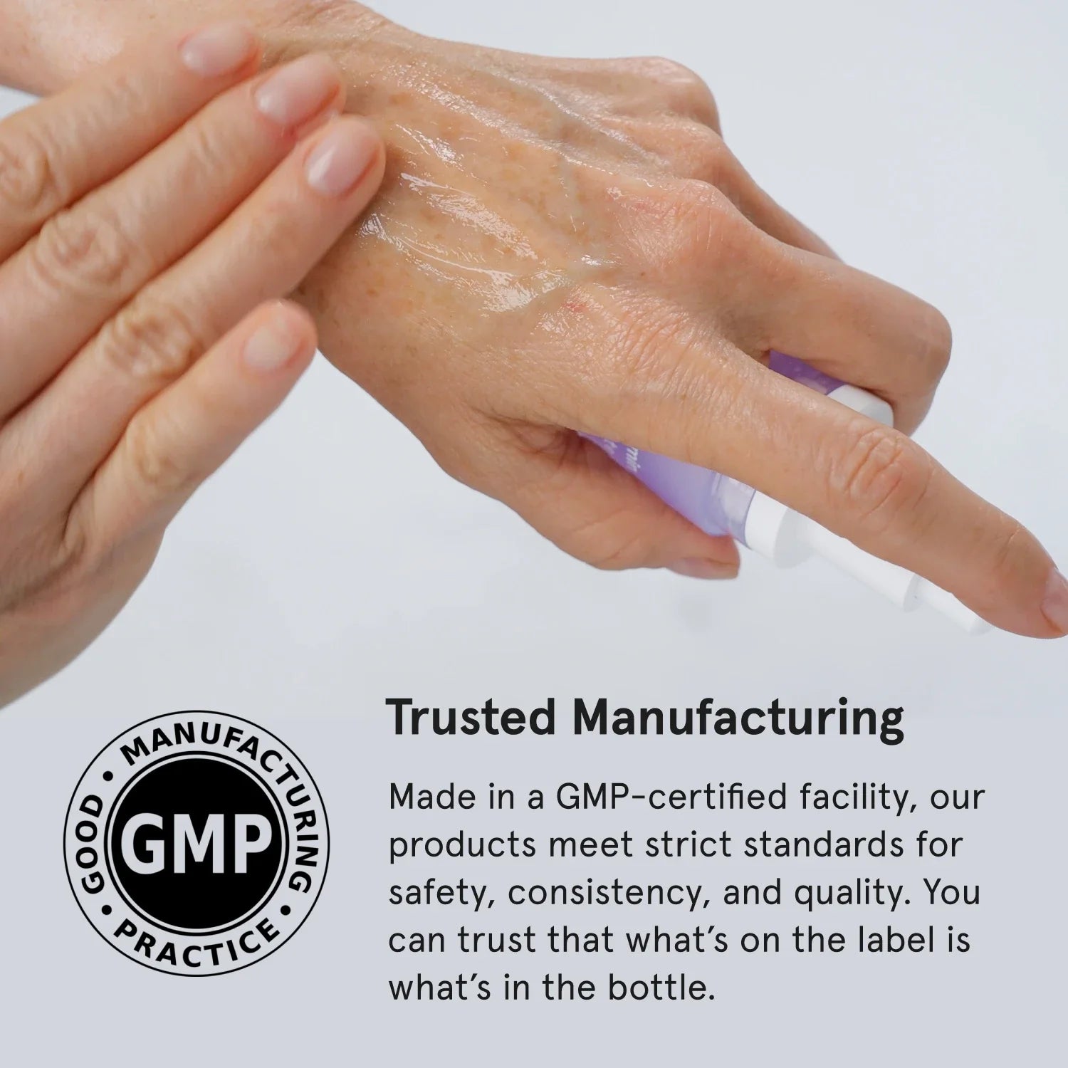 Hand applying Vitamin C Serum with a GMP certification logo and text on a white background